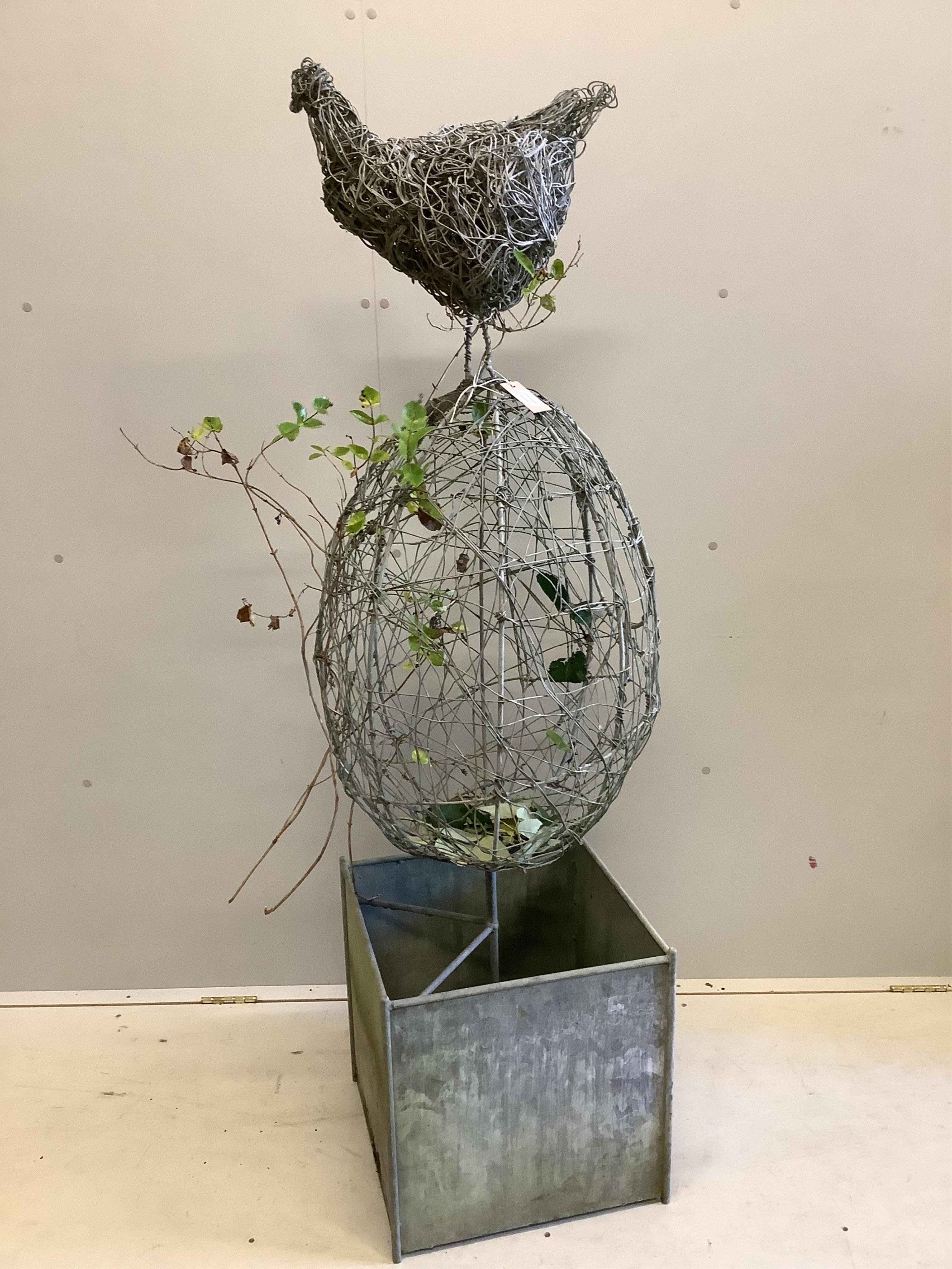 A Rupert Till wire work sculpture 'Chicken or Egg', on galvanised square trough base, height 164cm. Condition - weathered but fair